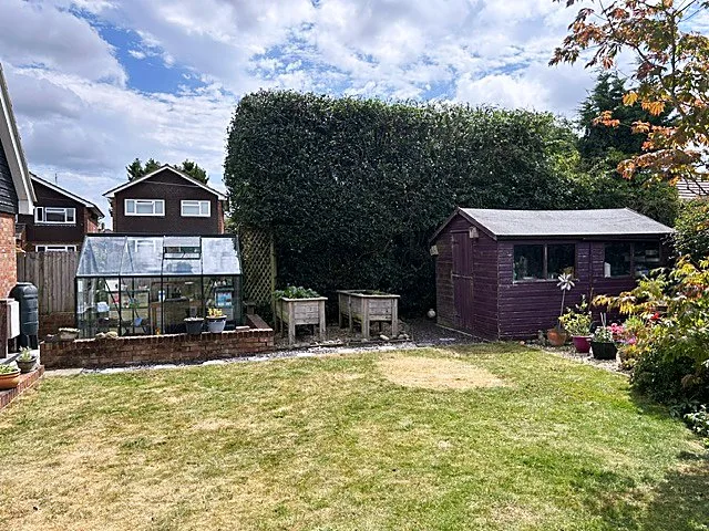 Trimmed hedge and tidy garden patio after maintenance work